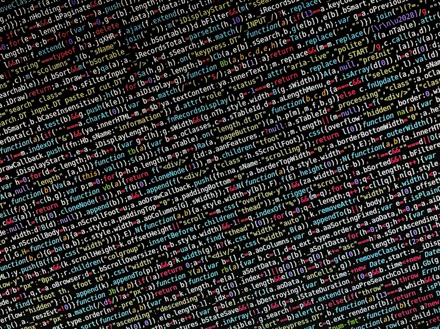 The image displays a close-up view of a dense screen of computer code, with lines of programming syntax in various bright colors including red, pink, green, blue, and white, on a black background. The